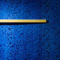 Blau gefärbte Holzplatten mit vergoldetem Aluminiumbalken